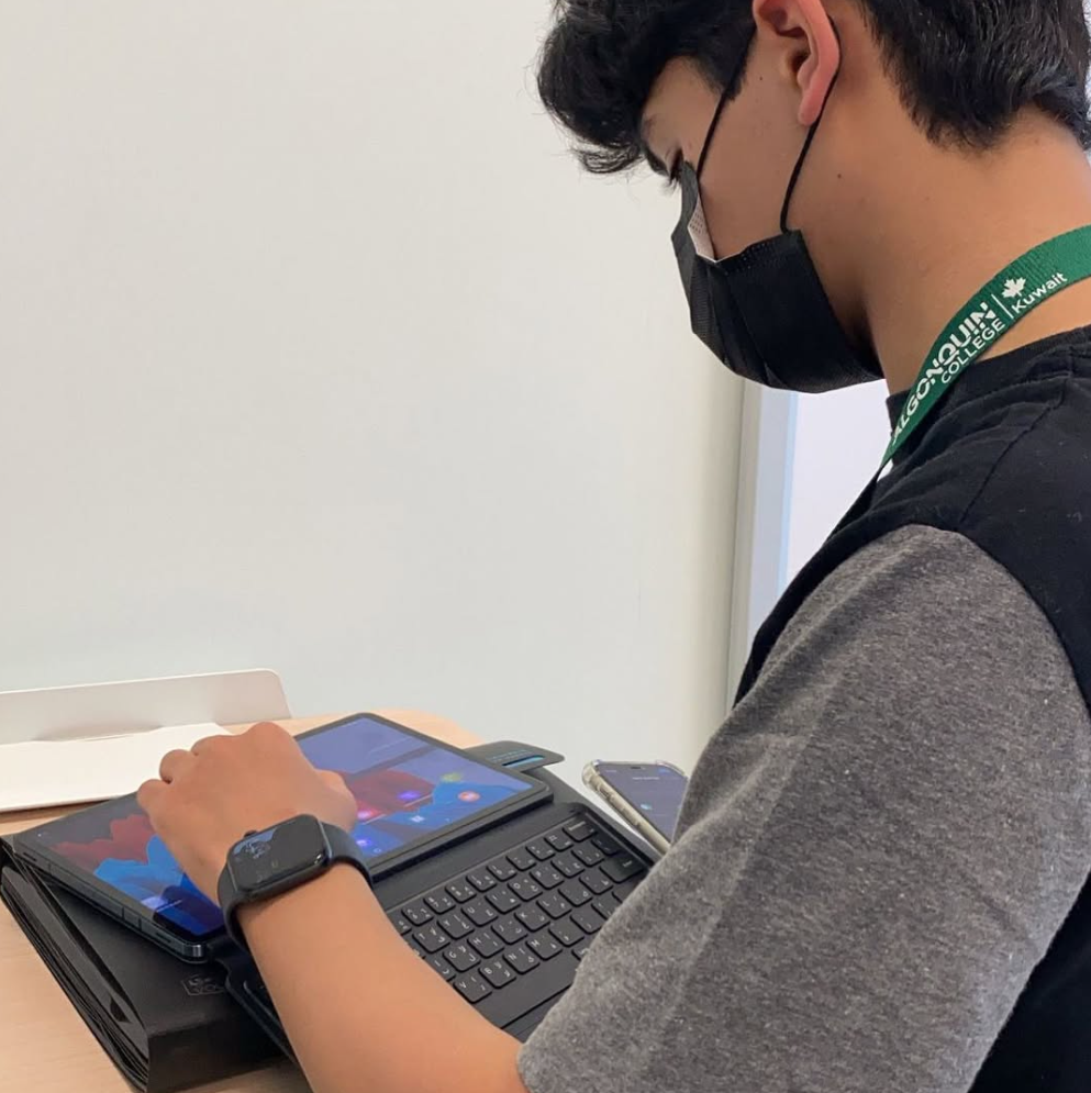 A student working on their device, engaged in academic tasks and coursework, showcasing a focused and productive learning environment.